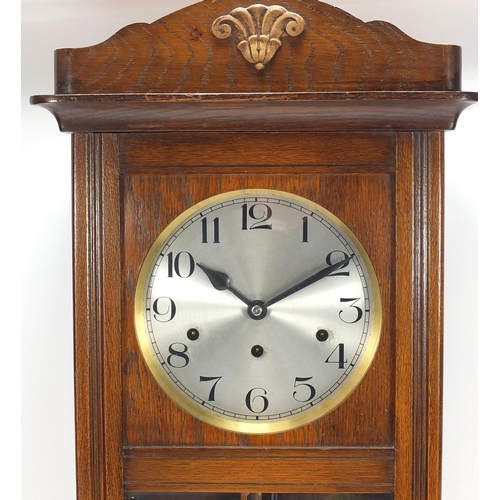 37 - Oak cased wall hanging clock with Westminster chime, 75cm in length