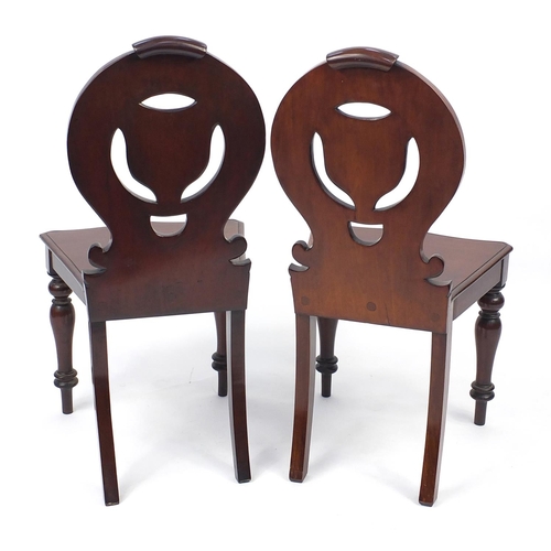 2005 - Pair of Victorian carved mahogany chairs raised on fluted legs, 86m high