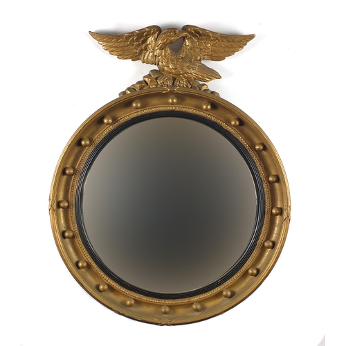 2018 - Circular gilt framed convex mirror with eagle crest, 65cm high