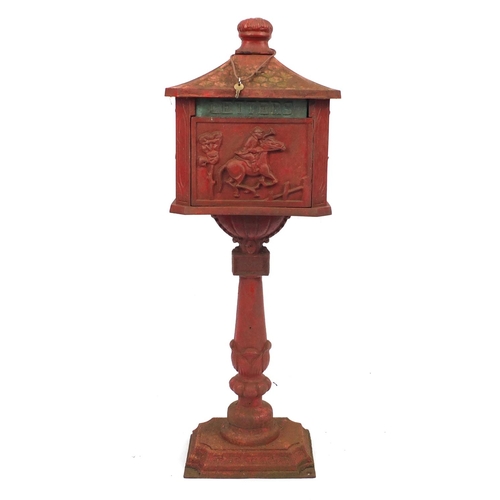 2039 - Cast iron free standing letterbox decorated with figure on horseback, 115cm high