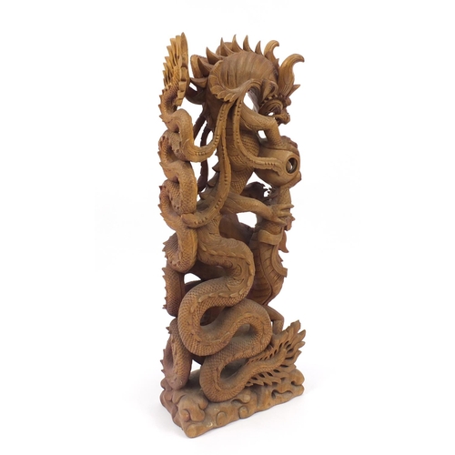 2044 - Floor standing carved wooden sculpture of two Chinese dragons chasing the pearl, 108cm high