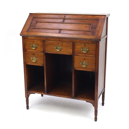 2031 - Aesthetic oak bureau with tooled leather top, above a fall enclosing a fitted interior over above an... 