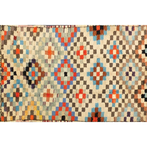2043 - Moroccan woollen rug having an all over geometric design, 250cm x 150cm