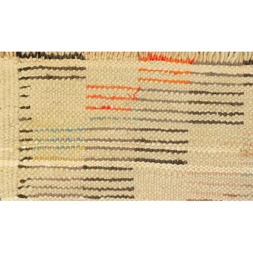 2043 - Moroccan woollen rug having an all over geometric design, 250cm x 150cm