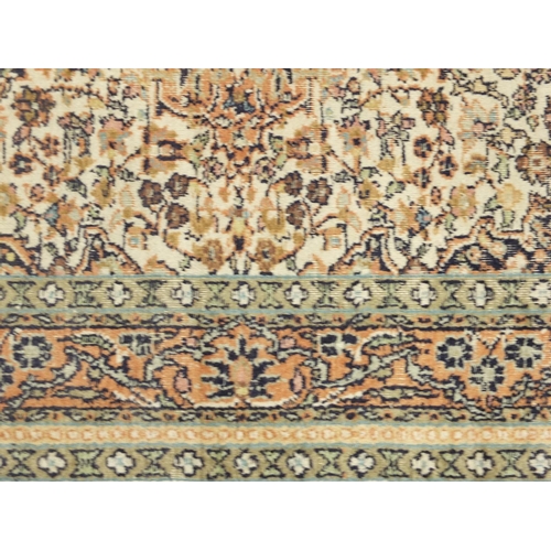2020 - Rectangular Kashmere silk rug having all over floral motifs onto a beige ground, 125cm x 82cm