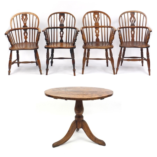 2015 - Circular yew tilt top table and a harlequin set of four Windsor elm stick back elbow chairs