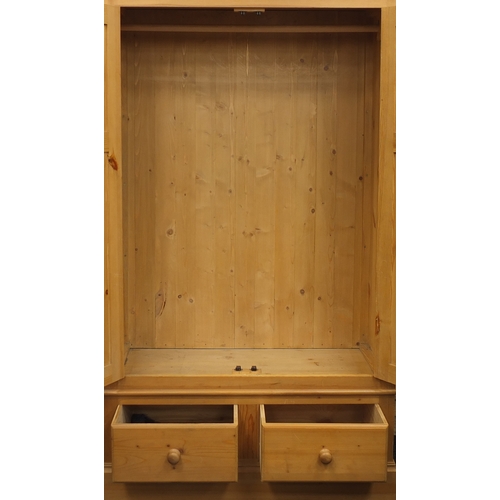 43 - Pine double wardrobe fitted with two drawers to the base, 206cm H x 120cm W x 58cm D