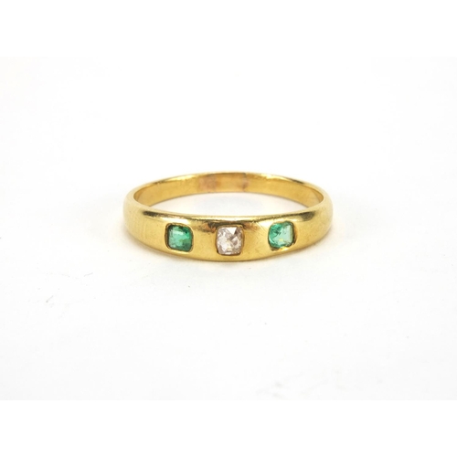 1045 - Unmarked gold emerald and diamond ring set with a central diamond and two emeralds, size N, approxim... 