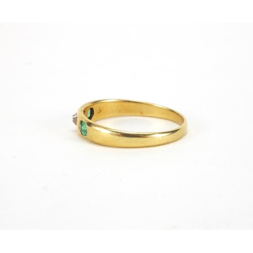 1045 - Unmarked gold emerald and diamond ring set with a central diamond and two emeralds, size N, approxim... 