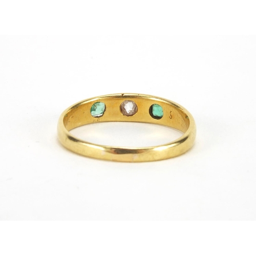 1045 - Unmarked gold emerald and diamond ring set with a central diamond and two emeralds, size N, approxim... 