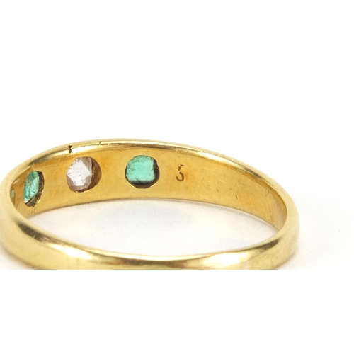 1045 - Unmarked gold emerald and diamond ring set with a central diamond and two emeralds, size N, approxim... 