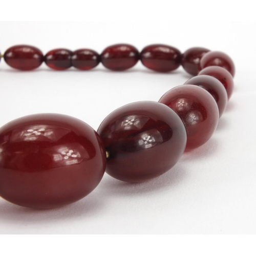 1059 - Cherry amber coloured bead necklace, 36cm in length, approximate weight 53.4g