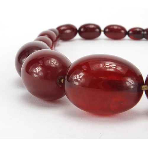 1059 - Cherry amber coloured bead necklace, 36cm in length, approximate weight 53.4g