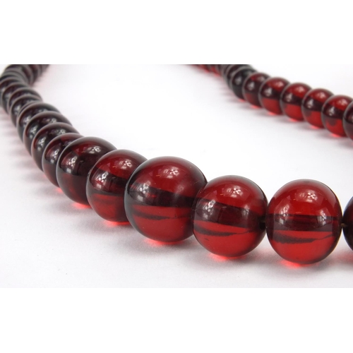 1060 - Four cherry amber coloured bead necklaces, the largest 80cm in length, approximate weight 205.0g