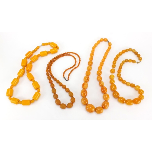 1054 - Three butterscotch amber coloured bead necklaces and one other, the largest, 66cm in length, approxi... 