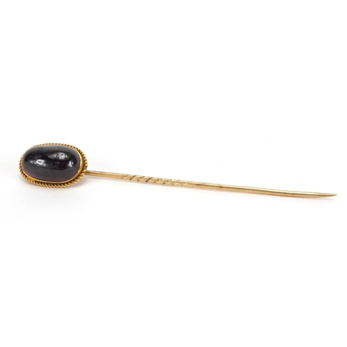 1051 - Gold coloured metal cabochon garnet tie pin, 8cm in length, approximate weight 4.7g