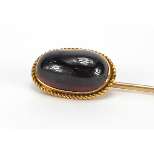 1051 - Gold coloured metal cabochon garnet tie pin, 8cm in length, approximate weight 4.7g