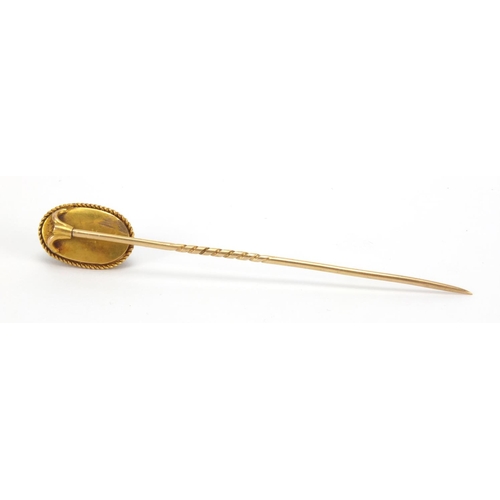 1051 - Gold coloured metal cabochon garnet tie pin, 8cm in length, approximate weight 4.7g