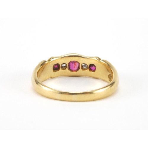 1014 - 18ct gold ruby an diamond ring set with three ruby's and two diamonds, size O, approximate weight 4.... 