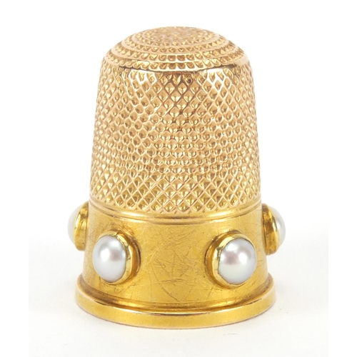 143 - Unmarked gold thimble set with five pearls, 2.5cm high, approximate weight 5.8g