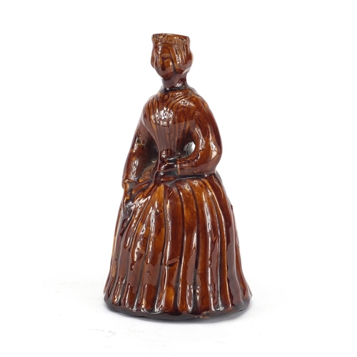 700 - Victorian treacle glazed pottery money box in the form of a crinoline lady, 18cm high