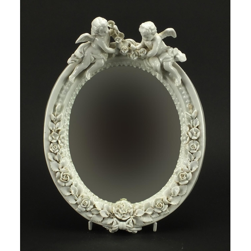 724 - 19th Century continental porcelain wall hanging mirror with floral encrusted decoration, mounted wit... 