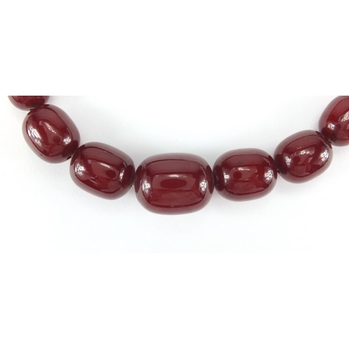 1058 - Cherry amber coloured bead necklace, 64cm in length, approximate weight 77.5g