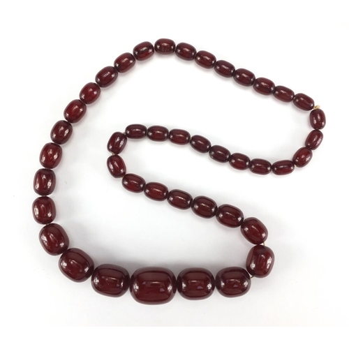 1058 - Cherry amber coloured bead necklace, 64cm in length, approximate weight 77.5g