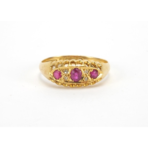 1043 - 18ct gold ruby and diamond ring set with three rubies and four diamonds, size Q, approximate weight ... 