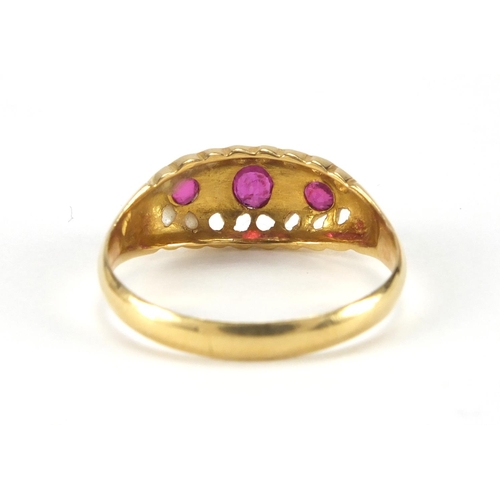 1043 - 18ct gold ruby and diamond ring set with three rubies and four diamonds, size Q, approximate weight ... 