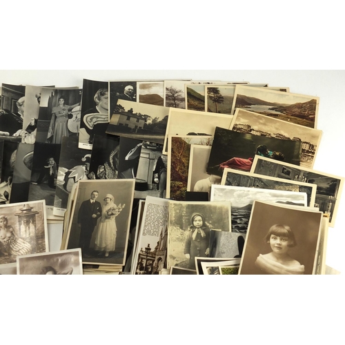 266 - Photographs and postcards including Harlech Castle, Stonehenge, nude Asian females, families and top... 