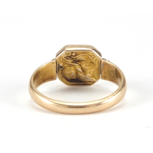 963 - Antique unmarked gold swivel ring embossed with a vulture and a Romans head, size F, approximate wei... 