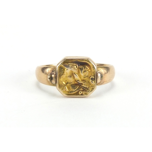 963 - Antique unmarked gold swivel ring embossed with a vulture and a Romans head, size F, approximate wei... 