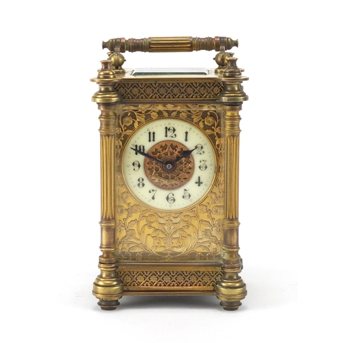 1129 - French brass cased carriage clock, with enamelled chapter ring, blind foliate fretwork and Corinthia... 