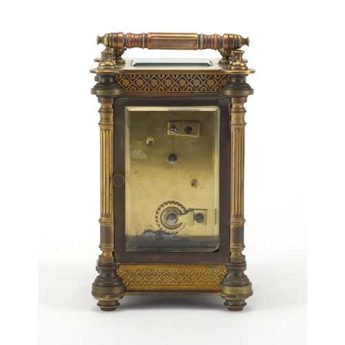 1129 - French brass cased carriage clock, with enamelled chapter ring, blind foliate fretwork and Corinthia... 