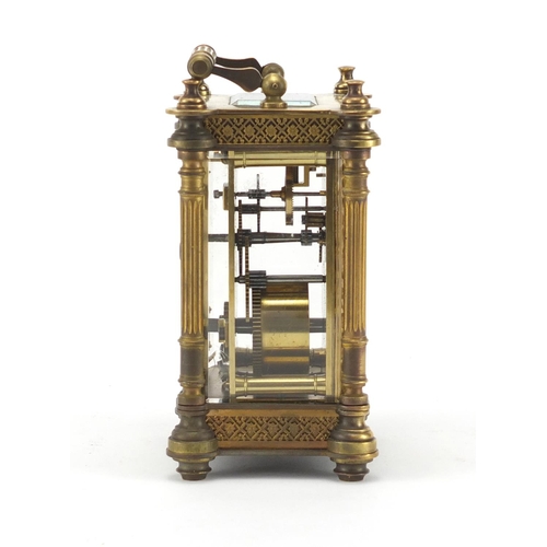 1129 - French brass cased carriage clock, with enamelled chapter ring, blind foliate fretwork and Corinthia... 