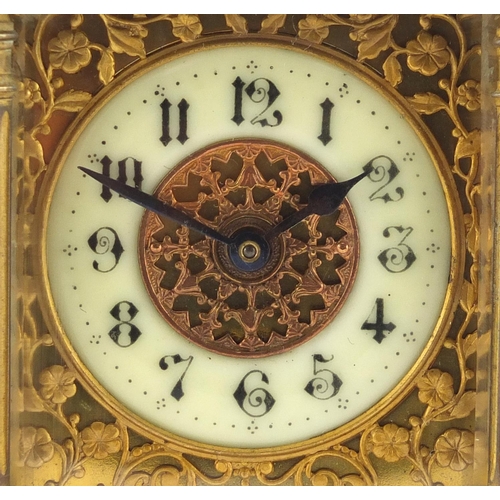 1129 - French brass cased carriage clock, with enamelled chapter ring, blind foliate fretwork and Corinthia... 