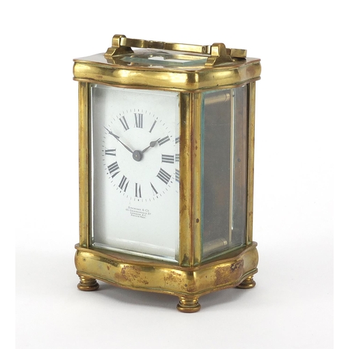 1132 - Victorian serpentine fronted brass carriage clock, the enamel dial with roman numerals for Stewart &... 