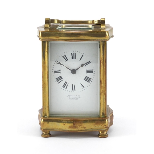 1132 - Victorian serpentine fronted brass carriage clock, the enamel dial with roman numerals for Stewart &... 