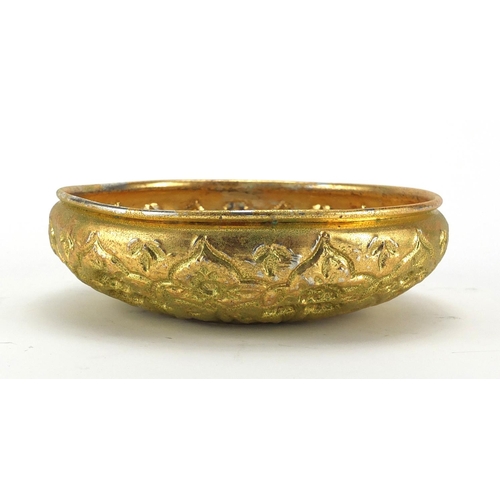 637 - Turkish gilt metal bathroom bowl embossed with stylised flowers and foliage, 21cm in diameter