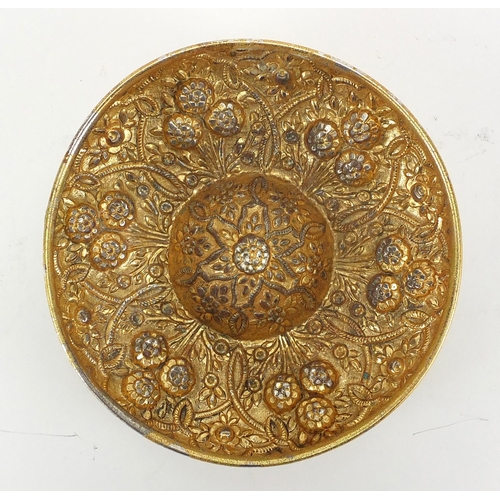 637 - Turkish gilt metal bathroom bowl embossed with stylised flowers and foliage, 21cm in diameter