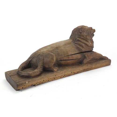 47 - Antique continental wood carving of a recumbent lion, 46cm wide