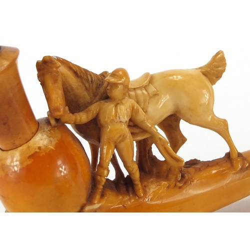 97 - Two Meerschaum style pipes and a pipe bowl, one of a man with his horse another of a female, the lar... 