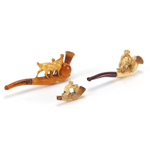 97 - Two Meerschaum style pipes and a pipe bowl, one of a man with his horse another of a female, the lar... 