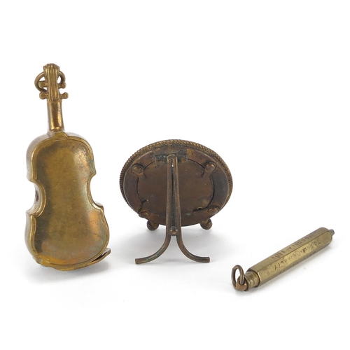 82 - Miscellaneous objects comprising a brass violin vesta case, micro mosaic easel photo frame and a Ken... 