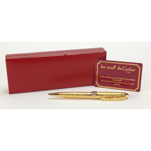 120 - Must De Cartier gold plated ball point pen with foliate decoration, together with certificate and bo... 
