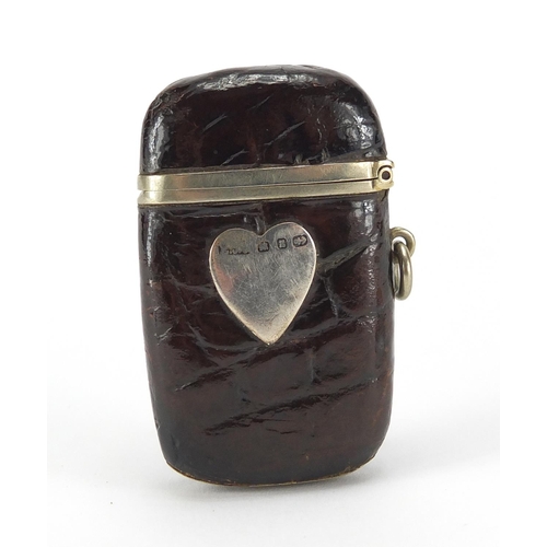 96 - Crocodile skin effect leather vesta case with silver love heart cartouche together with a glass exam... 