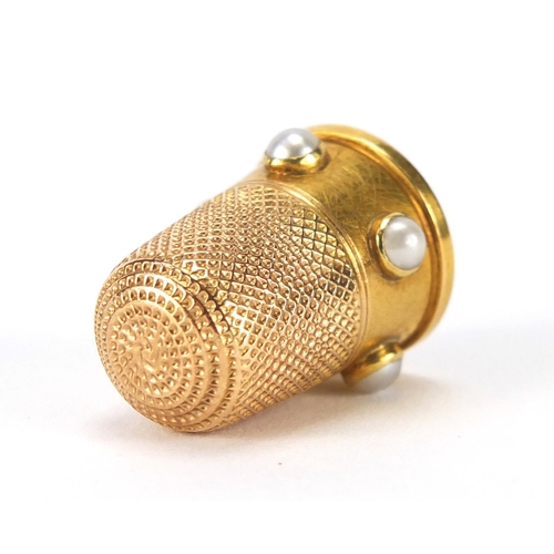 143 - Unmarked gold thimble set with five pearls, 2.5cm high, approximate weight 5.8g