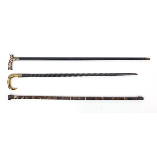 125 - Segmented bone walking cane together with two ebonised examples one with silver handle and one with ... 