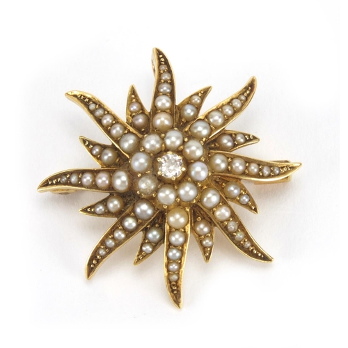 1021 - 15ct gold seed pearl star burst brooch set with a central diamond, 2.8cm in diameter, approximate we... 